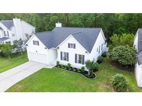 Bright, inviting two-story home featuring a well-manicured lawn and attached garage, set in a wooded neighborhood at 2560 Palmetto Hall Blvd, Mount Pleasant, SC 29466