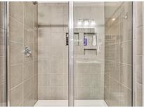 Tiled shower with glass door and built in shelves to hold soap and shampoo at 404 Snowy Plover Ln, Summerville, SC 29486