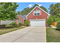 Charming two-story brick home featuring a two-car garage and well-manicured front lawn at 405 Decatur Dr, Summerville, SC 29486