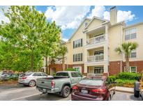 Inviting three-story condo with private balconies and lush landscaping, and ample parking spaces at 45 Sycamore Ave # 811, Charleston, SC 29407