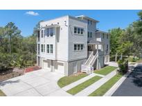 Stunning three-story home with a spacious driveway, two-car garage, and covered front porch at 4637 Bonnie Marie Way, North Charleston, SC 29405
