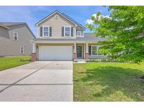 Charming two-story home with a well-manicured lawn, a two-car garage, and a welcoming front porch at 5032 Ballantine Dr, Summerville, SC 29485