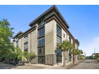 Modern building exterior with large windows, palm trees, and visible street access at 1 Cool Blow St # 337, Charleston, SC 29403