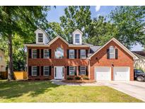 Two story brick home with black shutters, white trim, and two car garage at 107 Spalding Cir, Goose Creek, SC 29445