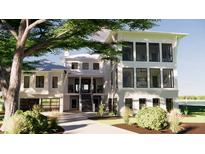 Beautiful three-story home showcasing a modern design with a charming driveway and lush landscaping at 11 Tabby Ln, Isle of Palms, SC 29451