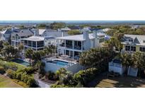 Stunning two-story home with a private pool, patio, and lush landscaping at 124 Charleston Blvd, Isle of Palms, SC 29451