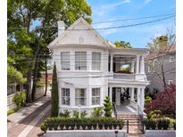 Charming white two-story home with a spacious front porch and well-maintained landscaping at 184 Ashley Ave, Charleston, SC 29403