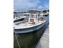 View of a white boat docked with brown leather seats and blue yamaha motor, in a marina setting at 1880 Andell Bluff Blvd # D-6, Seabrook Island, SC 29455