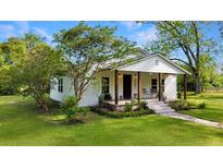 Charming single-story home with a covered front porch and well-manicured lawn at 224 Reeves St, Reevesville, SC 29471