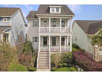 Charming two-story home with double porches and landscaped front yard at 2524 Josiah St, Charleston, SC 29492