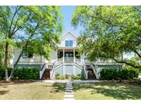 Charming home featuring double staircases leading to a covered porch and a manicured front lawn at 2538 Helmsman Rd, Johns Island, SC 29455