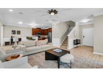 Inviting living room with a neutral color palette, modern furnishings and open layout to the kitchen and staircase at 3844 Annapolis Way, Ladson, SC 29456