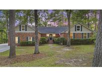 Charming brick home featuring a well-manicured lawn and symmetrical design, exuding curb appeal and classic charm at 418 Lakeview Dr, Summerville, SC 29485