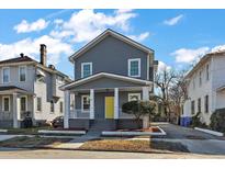Charming two-story home with gray siding, white trim, front porch, and a bright yellow front door at 55 Maple St, Charleston, SC 29403