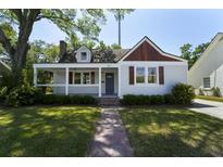 Charming home featuring a covered porch, manicured lawn, and delightful curb appeal at 81 Avondale Ave, Charleston, SC 29407