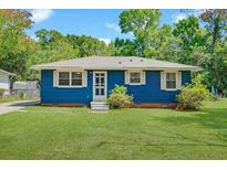 Charming single-story home with a blue exterior, well-manicured lawn, and inviting entrance at 1222 Maxwell St, North Charleston, SC 29405