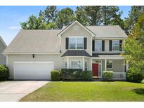 Charming two-story home boasts well-maintained landscaping, a red door, and a two-car garage at 1223 Creek Stone Way, Hanahan, SC 29410