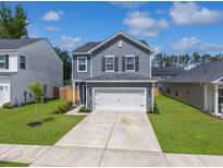 Charming two-story home with a well-manicured lawn and a two-car garage on a sunny day at 1441 Arabella St, Charleston, SC 29414
