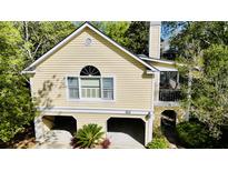 Charming two-story home featuring a front yard with a well-maintained lawn and an attached two-car garage at 1551 Ben Sawyer Blvd # 23, Mount Pleasant, SC 29464