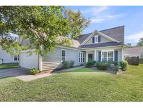 Charming single-Gathering home with manicured lawn, attached garage, and traditional architectural details at 1572 Pixley St, Charleston, SC 29414