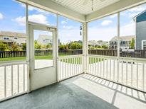 Relaxing screened patio with stamped concrete flooring and neighborhood views at 204 Lynx Ln, Summerville, SC 29483