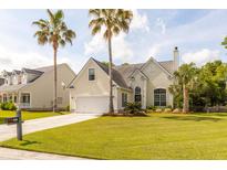 Charming two-story home featuring a well-manicured lawn and mature palm trees at 2632 Planters Pointe Blvd, Mount Pleasant, SC 29466
