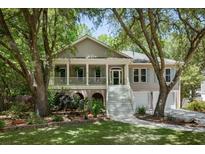 Charming two-story home featuring a welcoming front porch, classic columns, and a beautifully landscaped yard at 3021 Rushland Mews, Johns Island, SC 29455