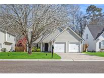Charming two-story home with a well-manicured lawn, mature tree and a two-car garage at 350 Arlington Dr, Charleston, SC 29414