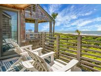 Relax on the deck with ocean views and comfortable seating, perfect for enjoying the coastal breeze at 4319 Sea Forest Dr, Kiawah Island, SC 29455