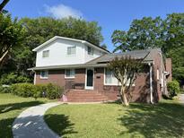 Charming two-story brick home featuring white siding, a landscaped yard, and a welcoming front entrance at 912 Kincade Dr Dr, Mount Pleasant, SC 29464