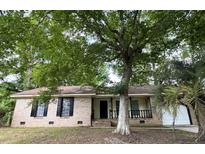 Charming brick ranch home with a cozy front porch and mature shade trees at 106 Pelican St, Ladson, SC 29456