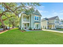 Charming two-story home featuring a covered porch, balcony, and landscaped front yard at 109 Gray Pine Ln, Summerville, SC 29483