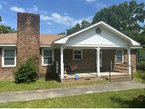 Charming brick home with a cozy front porch and classic design, perfect for relaxing in the outdoors at 111 Craven Rd, Ladson, SC 29456