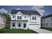 Charming two-story home with white siding, a gray roof, manicured landscaping, and an attached two-car garage at 127 Seaton St, Summerville, SC 29486