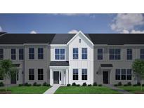 Charming townhome with light gray siding, black door, and manicured lawn creates a welcoming curb appeal at 133 Brown Swiss Cir, Summerville, SC 29483