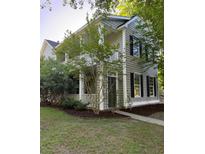Charming two-story home featuring a welcoming front porch and neatly landscaped front yard at 1418 Whispering Oak Trl, Mount Pleasant, SC 29466