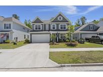 Charming two-story home with a manicured lawn, a two-car garage, and attractive landscaping at 160 Cherry Grove Dr, Summerville, SC 29483