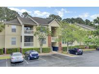 Inviting condo exterior boasting two stories, quaint balconies, lush landscaping, and convenient parking at 1600 Long Grove Drive # 811, Mount Pleasant, SC 29464