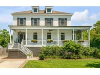 Inviting two-story home featuring a charming front porch and well-manicured lawn at 2 Piedmont Ave # A, Charleston, SC 29403