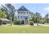 Charming blue two-story home with double front porches and manicured landscaping at 2919 Zachary George Ln, Johns Island, SC 29455