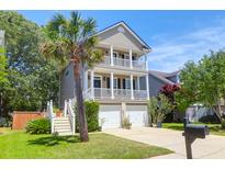Charming two-story home featuring double balconies, a well-manicured lawn and a lovely palm tree at 352 Clayton Dr, Charleston, SC 29414