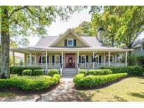 Charming home featuring a welcoming front porch, manicured landscaping, and an inviting entrance at 707 Royall Ave, Mount Pleasant, SC 29464