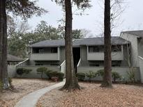 Two-story condo with grey siding, a walkway and mature landscaping in a desirable community at 1198 Village Creek Ln # 301, Mount Pleasant, SC 29464