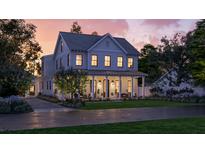 Inviting two-story home with a charming wraparound porch and lush green lawn at 1430 Hindman Ave, Mount Pleasant, SC 29464