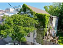 Exterior view of a weathered house with vines and trees at 20 Felix St, Charleston, SC 29403