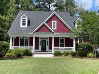 Charming two-story home featuring a landscaped front yard and covered porch at 208 Molasses Mill Ct, Summerville, SC 29485