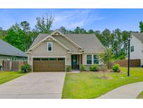 Charming single-story home with a well-manicured lawn and a two-car garage at 219 Whirlaway Dr, Moncks Corner, SC 29461