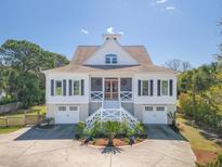 Charming two-story home with a welcoming entrance and a well-manicured front yard at 3013 Middle St, Sullivans Island, SC 29482