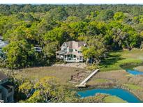Beautiful waterfront home nestled among lush trees with private dock and expansive views at 3104 Upda Creek, Seabrook Island, SC 29455