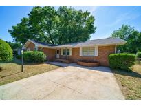 Charming single-story brick home featuring a spacious driveway and mature landscaping at 779 Dills Bluff Rd, Charleston, SC 29412